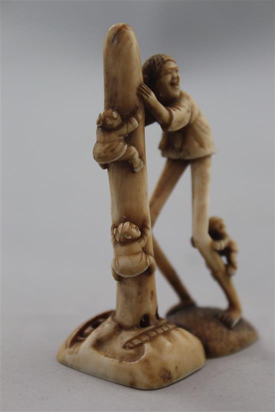 A Japanese ivory netsuke of Ashinaga holding the nose of a Tengu mask, Edo period, 6.9cm